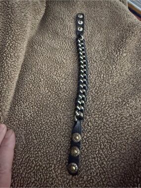 Henri Bendel black leather silver chain bracelet has snaps that are the HB logo.